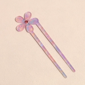 Detail of a lilac acetate U-shaped hair pin with a sparkling pink floral rhinestone