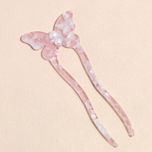 Detailed view of pink acetate butterfly hair pin with pearls and wave prongs
