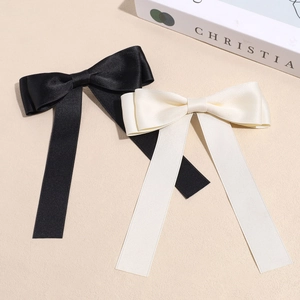 Elegant satin bow hair clips in black and off-white with long ribbons for women