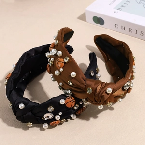 Nahaufnahme eines geknoteten Stirnbands mit Perlen, Strass und Basketball-Anhängern