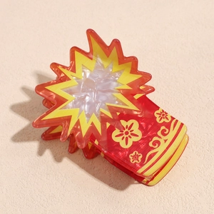 Detail view of red and yellow acetate hair claw clip with traditional Chinese cloud patterns
