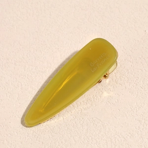 Detailed macro view of olive green acetate hair clip with Barrette la France text