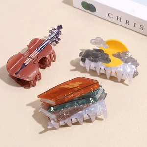 Pinces à cheveux artistiques en acétate en forme de violon et de livre tons coucher de soleil