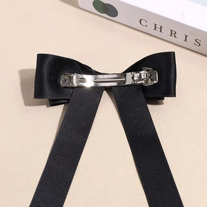 Elegant black satin bow hair clip with long ribbons and premium metal spring clip