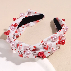 Geknotetes Stoffstirnband mit Herz- und Bärenprints und rosa-roten Perlenverzierung