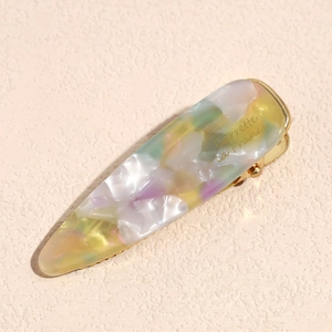 Detail of a colorful marble acetate hair clip with Barrette La France gold engraving