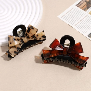 Tortoiseshell and amber acetate bow hair claws for elegant hairstyling and buns
