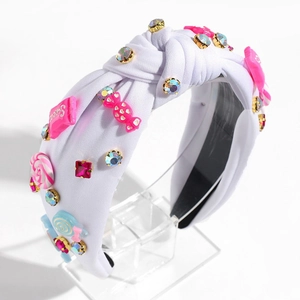 Details des weißen Knotenstirnbands mit bunten Süßigkeiten-Ornamenten und Kristallen