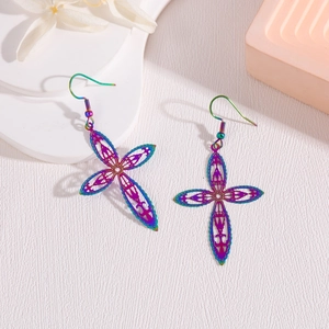 Gros plan de boucles d'oreilles croix en acier inoxydable irisé avec motifs évidés