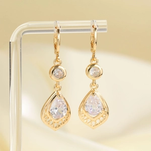 Luxurious gold teardrop earrings with sparkling zircon crystals and hollow carved details