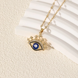 Elegant gold Evil Eye pendant necklace with blue zircon and star on white platform