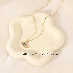 Golden evil eye pendant necklace with blue zircon stones on a cream tray, 40+5cm length