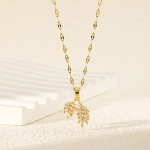 Elegant gold necklace with geometric zircon wheat ear pendants on a stylish chain