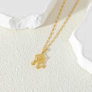 Golden snowflake dreamcatcher pendant necklace with sparkling zircons on white stone