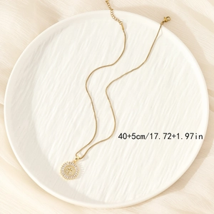 Hiphop gold circular cross pendant necklace with sparkling cubic zirconia on white background