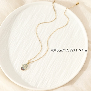 Titanium steel Hamsa Hand necklace with colorful rhinestones on a white ceramic tray