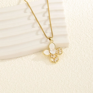 Collier papillon doré élégant avec zircon en cœur et nacre sur un présentoir blanc