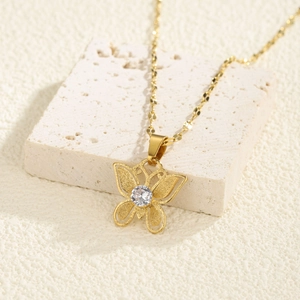 Golden butterfly pendant necklace with frosted details and sparkling central zircon stone
