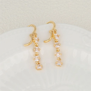 Elegant gold plated drop earrings featuring four square zircons hanging on a white plate