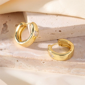 Polished gold hoop earrings featuring a sparkling heart-shaped zircon inlay for women