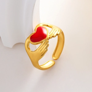 Gold adjustable ring featuring two hands holding a red enamel heart in a romantic style