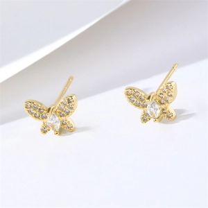 Elegant gold butterfly stud earrings inlaid with sparkling cubic zirconia on a white surface
