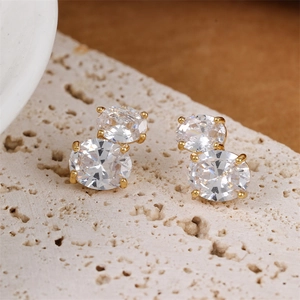 Elegant gold double drop earrings with oval cubic zirconia on a natural stone base