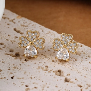 Golden clover stud earrings with pavé zircons and pear-shaped crystals on stone