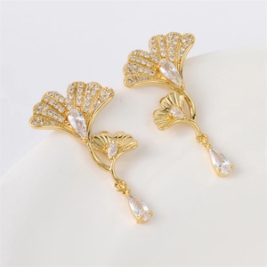Golden ginkgo leaf earrings with shimmering zircons and teardrop crystal pendants