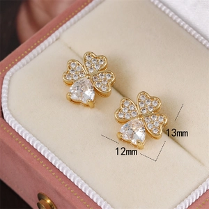 Micro-pave zircon four-leaf clover stud earrings with heart-shaped stone set in gold