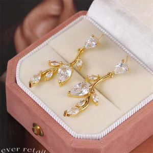 Leaf tassel earrings with zircon stones presented in a pink velvet jewelry box