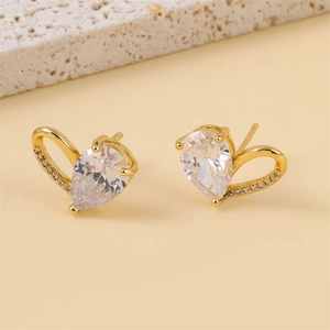 Golden openwork heart earrings with pear-cut zircon and white stone accents