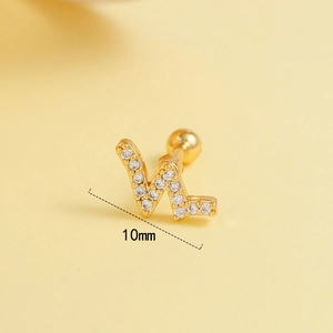 Macro view of 10mm golden W-shaped letter ear stud with sparkling zircon pavé detail