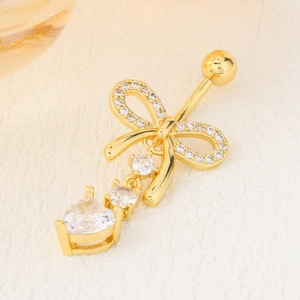 Golden butterfly navel ring with cubic zirconia inlay and heart-shaped pendant