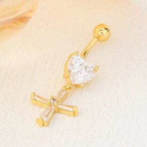 Piercing nombril cœur et croix doré avec zircon cubique étincelant sur surface texturée