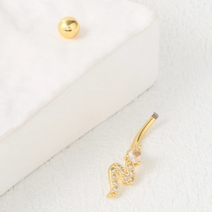 Golden snake navel ring with shimmering cubic zirconia crystals on white geometric stand