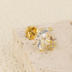 Detailed macro view of a gold umbrella stud earring with zircon inlay and screw ball back