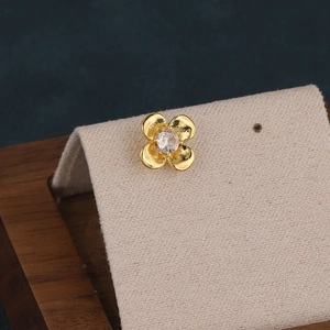 Detail view of a 1.0mm stainless steel flower stud earring on a beige display stand