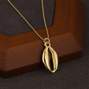 Elegant gold shell pendant necklace on wooden stand with a delicate box chain