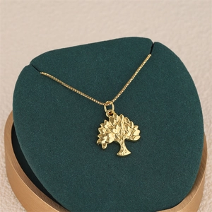 Elegant 18K gold-plated tree of life pendant necklace on premium velvet display