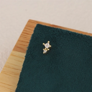 Macro shot of 18K gold plated earring with square and round cubic zirconia studs