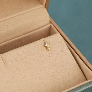 Macro shot of 18K gold plated earring with square and round cubic zirconia stones