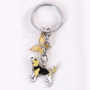 Detail view of foxhound dog and butterfly charms on a silver metal keychain