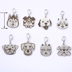 Close-up of stainless steel pet ID tags with lobster clasps and cartoon dog breeds