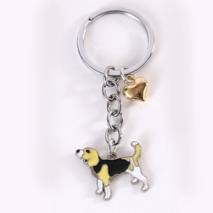 Close-up of beagle dog enamel pendant with gold heart charm on metal keychain