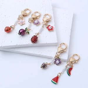 Fruit keychain set with strawberry and grape charms, gold metal with pearls