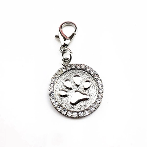 Close-up of sparkling rhinestone paved paw print pendant with durable lobster clasp