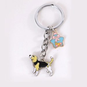 Detail of cartoon beagle keychain with blue star bottle pendant and silver metal ring
