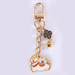 Detailed view of white zodiac pony keychain with golden sycee and blue flower pendant