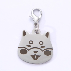 Close-up of shiba inu shaped stainless steel pet ID tag with lobster clasp and ring